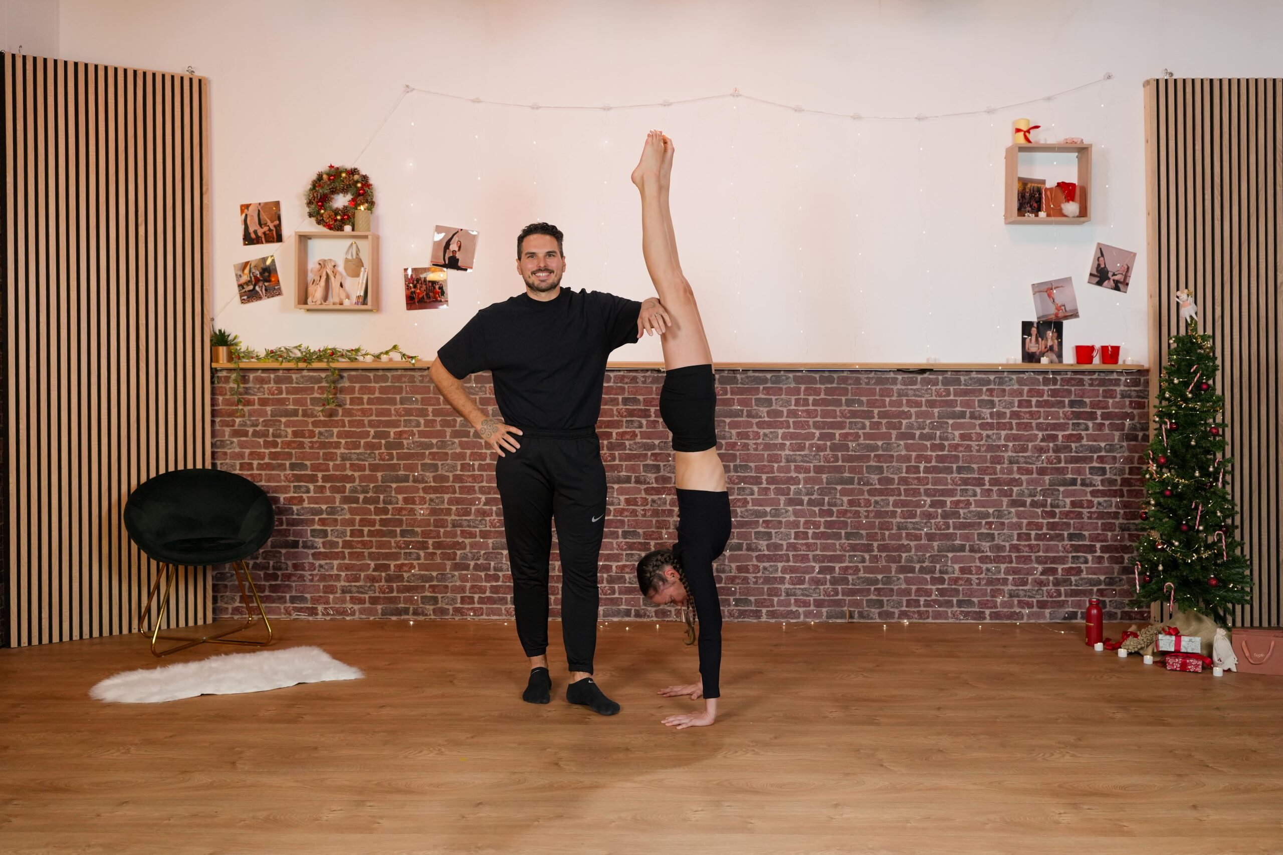Handstand débutant : Jessica en équilibre sur les mains, assistée par un coach